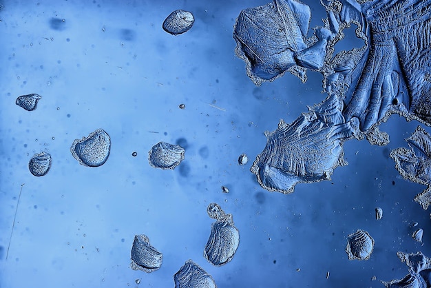 blue ice glass background, abstract texture of the surface of the ice on the glass, frozen seasonal water