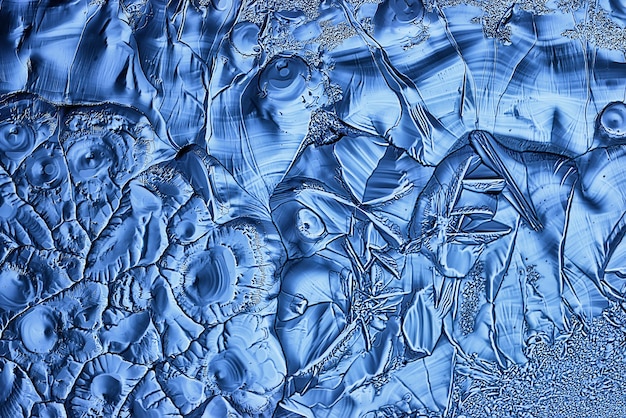 blue ice glass background, abstract texture of the surface of the ice on the glass, frozen seasonal water