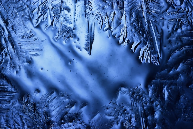 blue ice glass background, abstract texture of the surface of the ice on the glass, frozen seasonal water