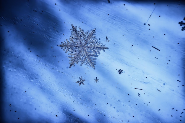 blue ice glass background, abstract texture of the surface of the ice on the glass, frozen seasonal water