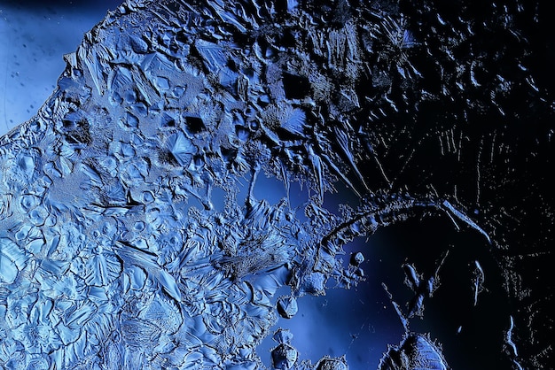 blue ice glass background, abstract texture of the surface of the ice on the glass, frozen seasonal water