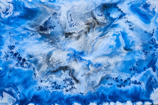 Blue ink abstract background winter paint pattern under water acrylic pigment stains splashes and streaks