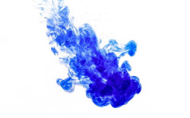 Blue ink injected into water from syringe, colour mixing with water creating abstract shapes