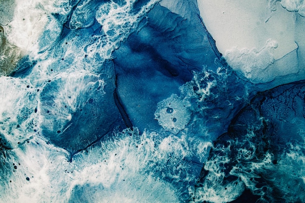 Blue ink water. Marble texture. Ocean surface with white wave foam effect. Aerial sea. Mineral stone streak pattern. Abstract nature background. Healing energy.