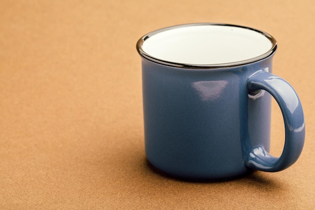 Blue iron mug on a brown background