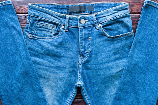 Blue jeans on a wooden background