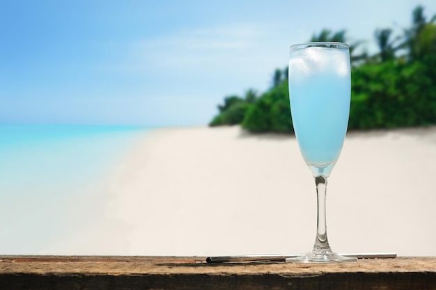 Blue lagoon alcoholic cocktail Glass of summer cocktail on tropical beach bar