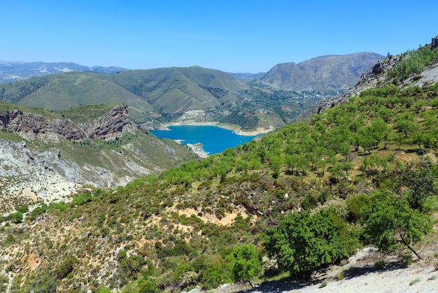 Blue lake in Sierra Nevada National Park, near Granada, Spain. Summer mountain landscape.