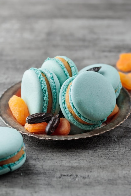 Photo blue macaroons on a grey concrete background vertical