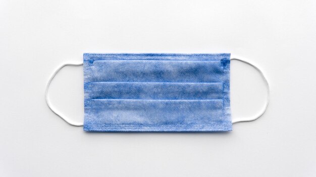 Blue medical surgical mask isolated on a white background Closeup photo