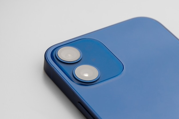 Blue modern smartphone with doublelens camera on gray