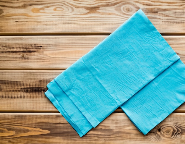 Blue Napkin on wooden table top view