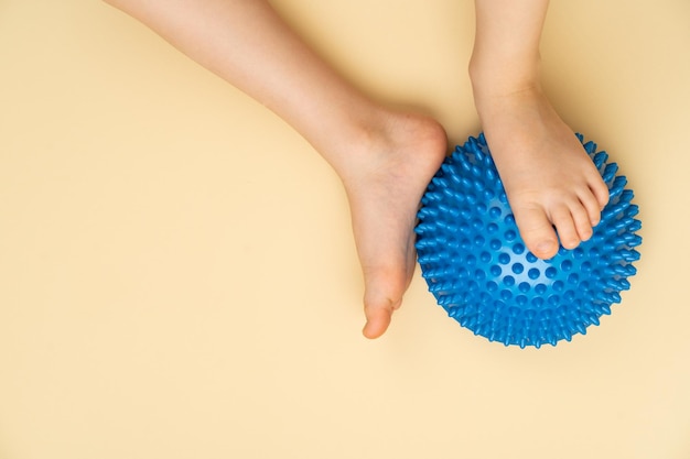 Blue needle balancing ball for massage and physiotherapy on a beige background with the image of a