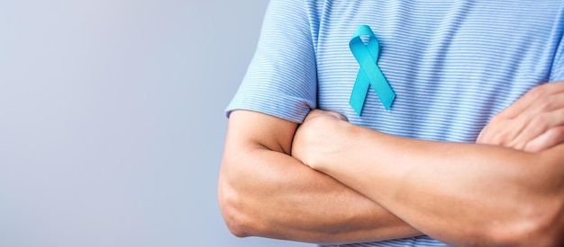 Blue November Prostate Cancer Awareness month Man in blue shirt with hand holding Blue Ribbon for support people life and illness Healthcare International men Father Diabetes and World cancer day