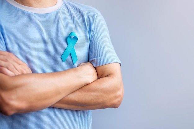 Blue November Prostate Cancer Awareness month Man in blue shirt with hand holding Blue Ribbon for support people life and illness Healthcare International men Father Diabetes and World cancer day