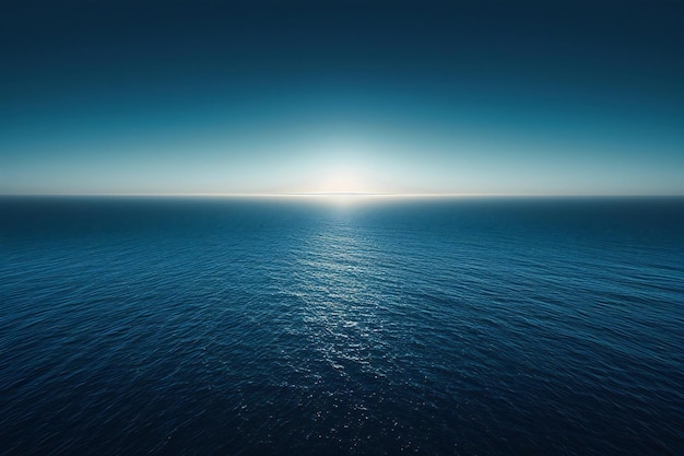 Photo a blue ocean with a sun setting over the horizon