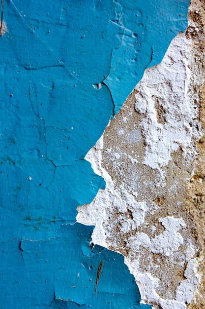 Blue old chipped  paint on a concrete wall old wall texture