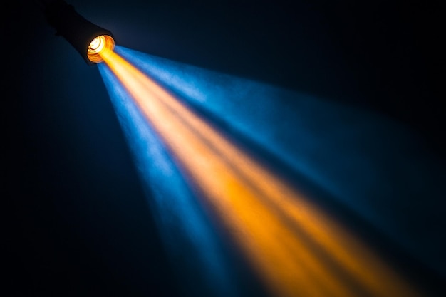 A blue and orange light is shining on a black background