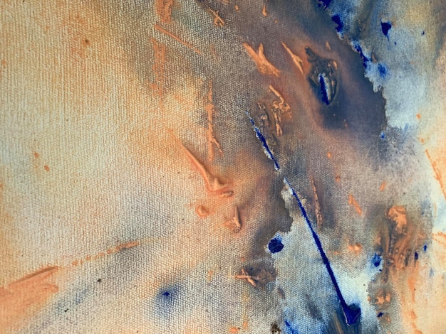 A blue and orange painting with a white background and blue paint.