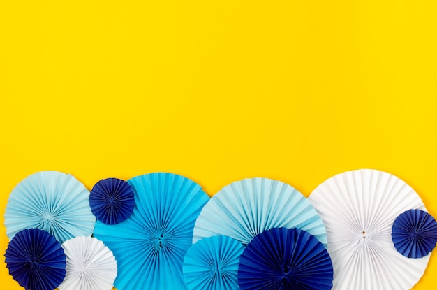 Blue paper fan medallion on yellow background