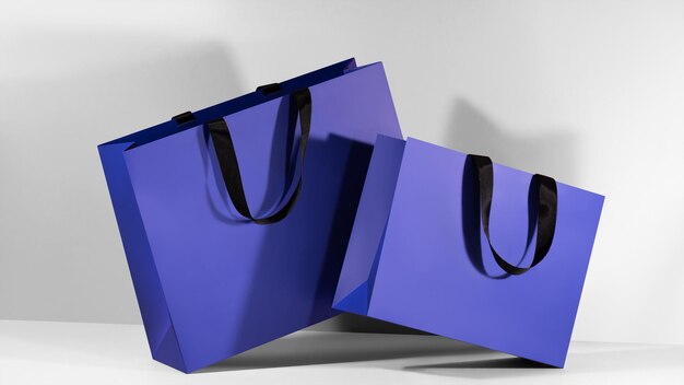 Blue paper shopping bags mockup with black handles