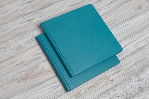 Blue photobooks on a wooden table