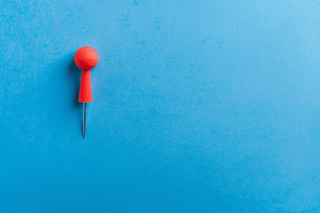 a blue piece of paper with a red triangle on it