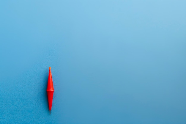 a blue piece of paper with a red triangle on it