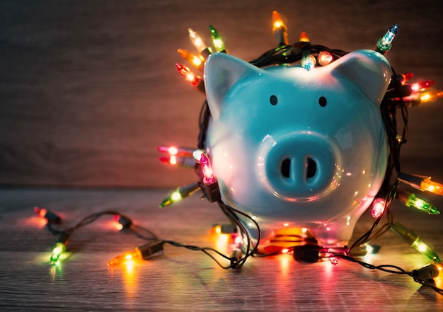 Blue piggy bank with Party lights, Enjoy savings for the holidays concept.