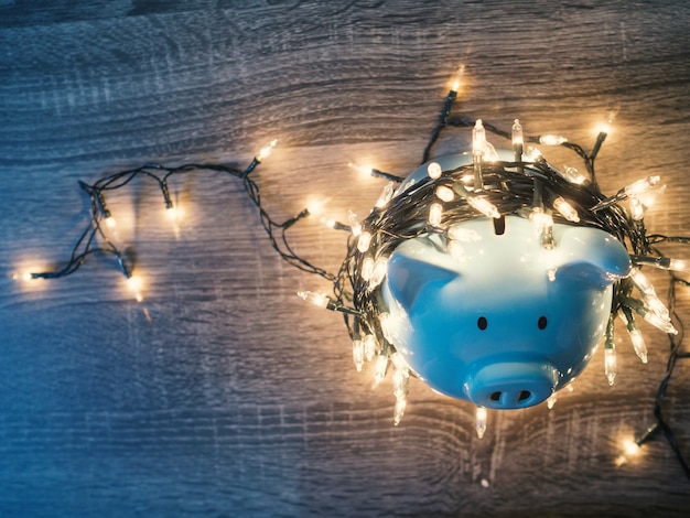 Blue piggy bank with Party lights, Enjoy savings for the holidays concept.