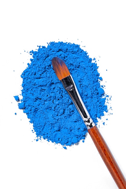 blue pigment dry paint on a white background macro