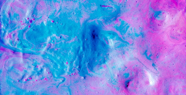 A blue and pink painting of a man's face with a hole in it.