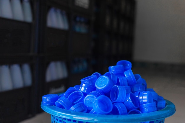 Blue plastic water bottle cap Lots of piles together in a plastic basket in drink water