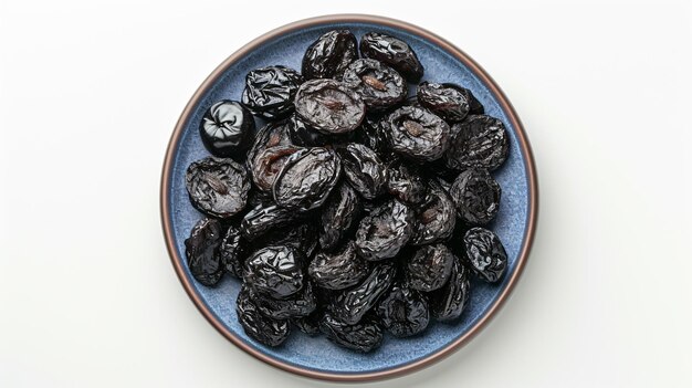 Blue plate full of dried tasty plums on white