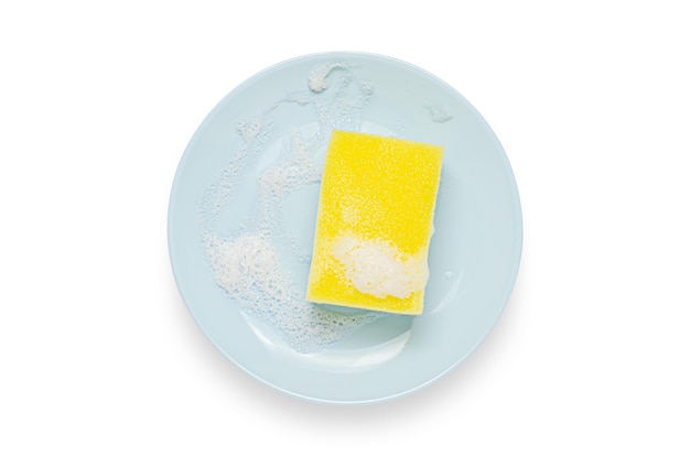 A blue plate with soap suds Washing dishes after eating Isolated on a white background