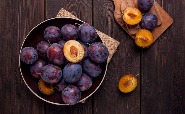 Blue plum on a wooden table top view closeup no people