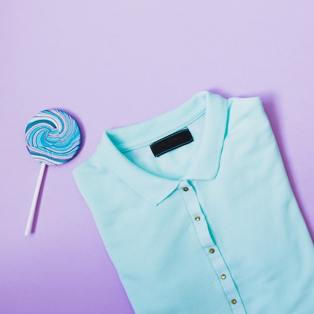 blue polo t-shirt and lollipop in minimal stylish concept