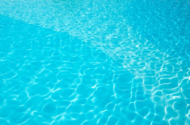 Blue pool water with sun reflections