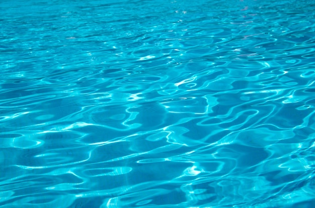 Blue pool water with sun reflections