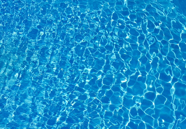 Blue pool water with sun reflections