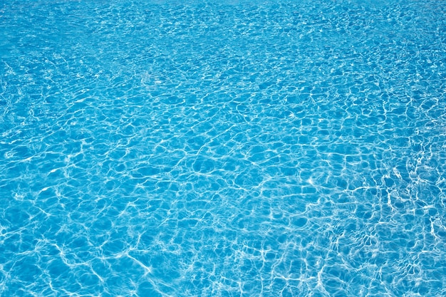 Blue pool water with sun reflections