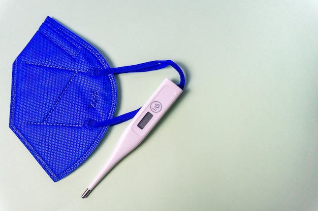 Blue protective mask with a thermometer o