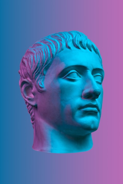 Blue purple gypsum copy of ancient statue of Germanicus Julius Caesar head for artists isolated on color background Renaissance epoch Plaster sculpture of man faceTemplate for art design