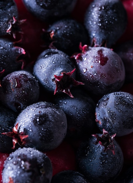 Blue and purple wild shadberries closeup. Macro food background