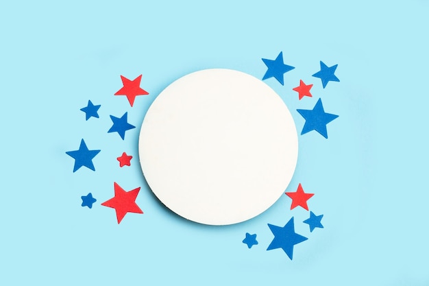 Blue and red stars and a round blank white copy space on a light blue background in a top view