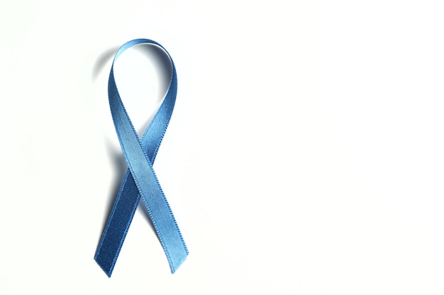 Blue ribbon on a white background against child abuse and symbol in defense of education