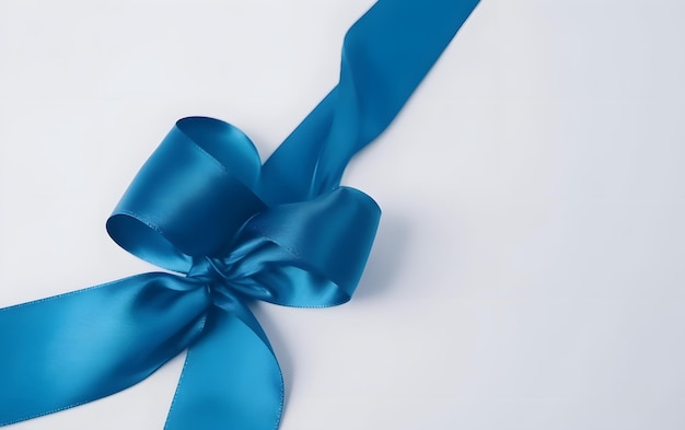 A blue ribbon with a bow on a white background