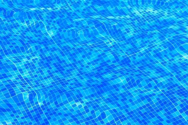 Blue ripped water in swimming pool background.