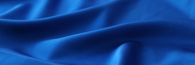 Blue satin background or design element Waved blue fabric close up