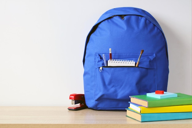 A blue school backpack and textbooks